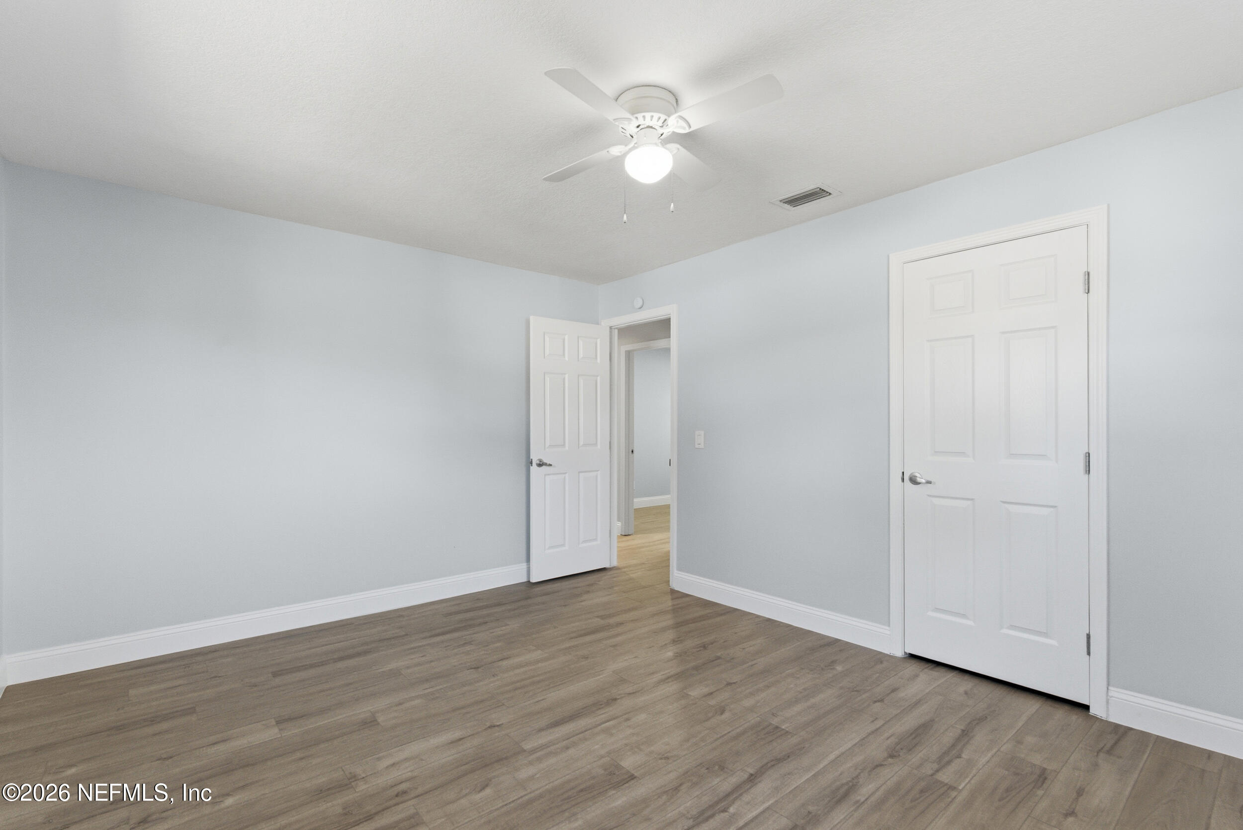 97150 Caravel Trail Yulee, FL 32097 - Photo 27 of 35 a view of an empty room with wooden floor