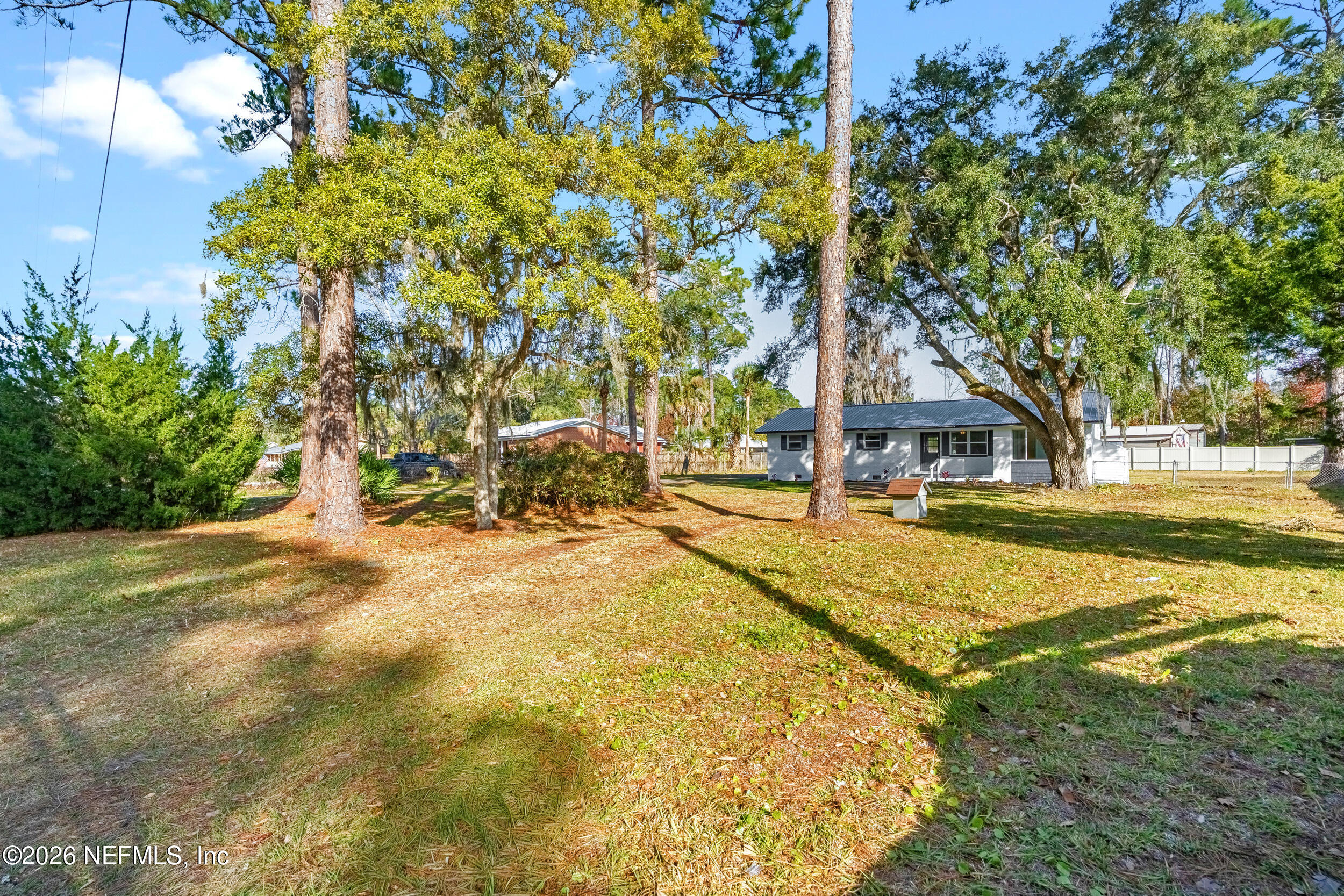 97150 Caravel Trail Yulee, FL 32097 - Photo 3 of 35 a view of yard with swimming pool and trees