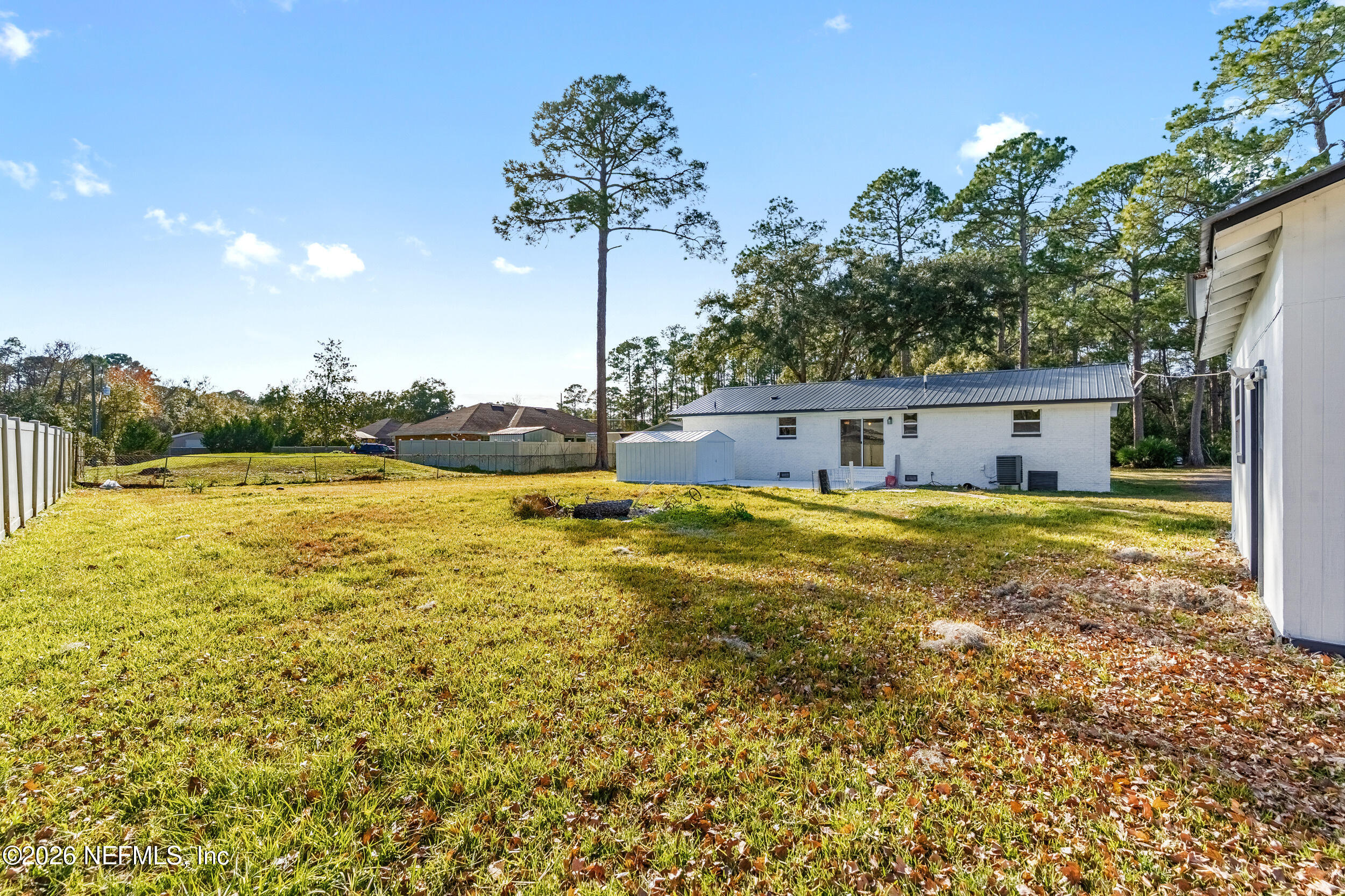 97150 Caravel Trail Yulee, FL 32097 - Photo 31 of 35 a house view with swimming pool and yard