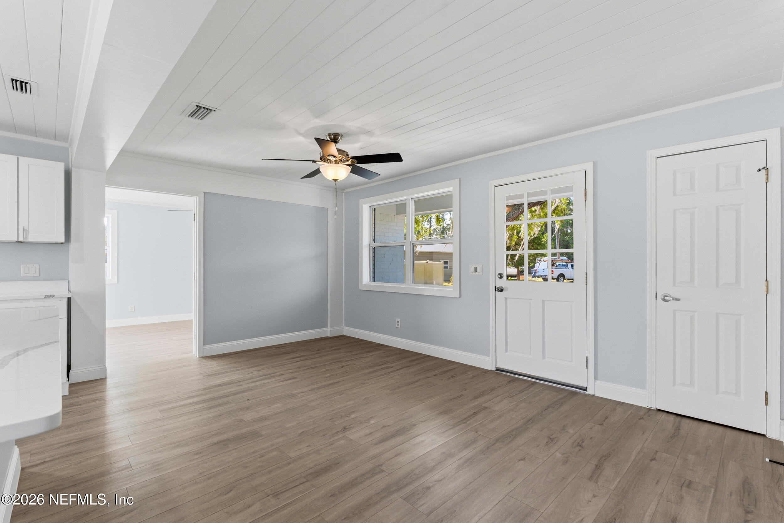 97150 Caravel Trail Yulee, FL 32097 - Photo 8 of 35 a view of an empty room with wooden floor and a window