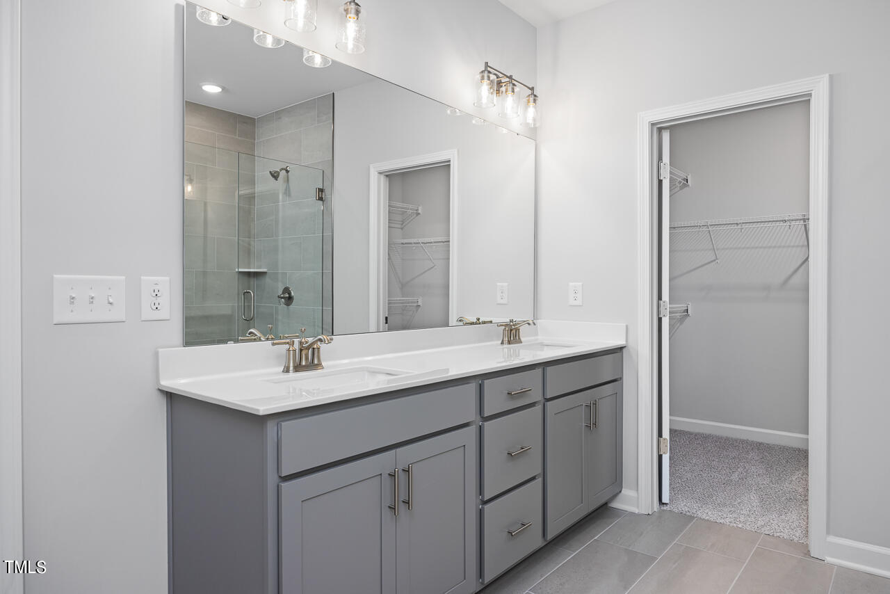 83 Golden Leaf Farms Road Angier, NC 27501 - Photo 18 of 25 a bathroom with a double vanity sink and mirror