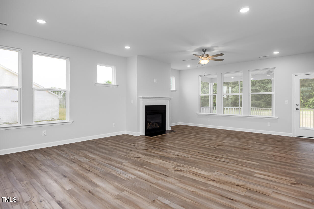 83 Golden Leaf Farms Road Angier, NC 27501 - Photo 8 of 25 a view of empty room with wooden floor and fan