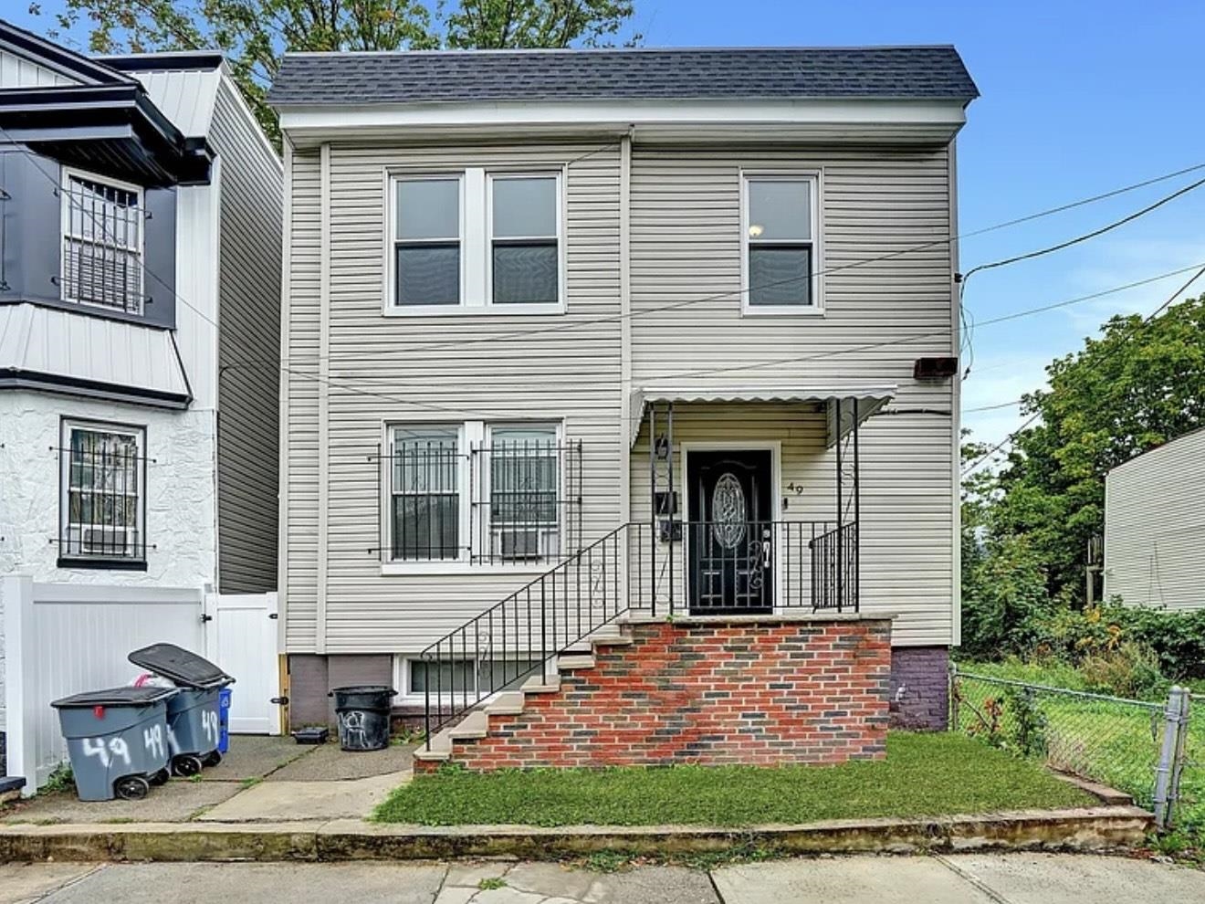 49 Tichenor Terrace, Unit 2 Irvington, NJ 07111 - Photo 8 of 9 a front view of a house with garden
