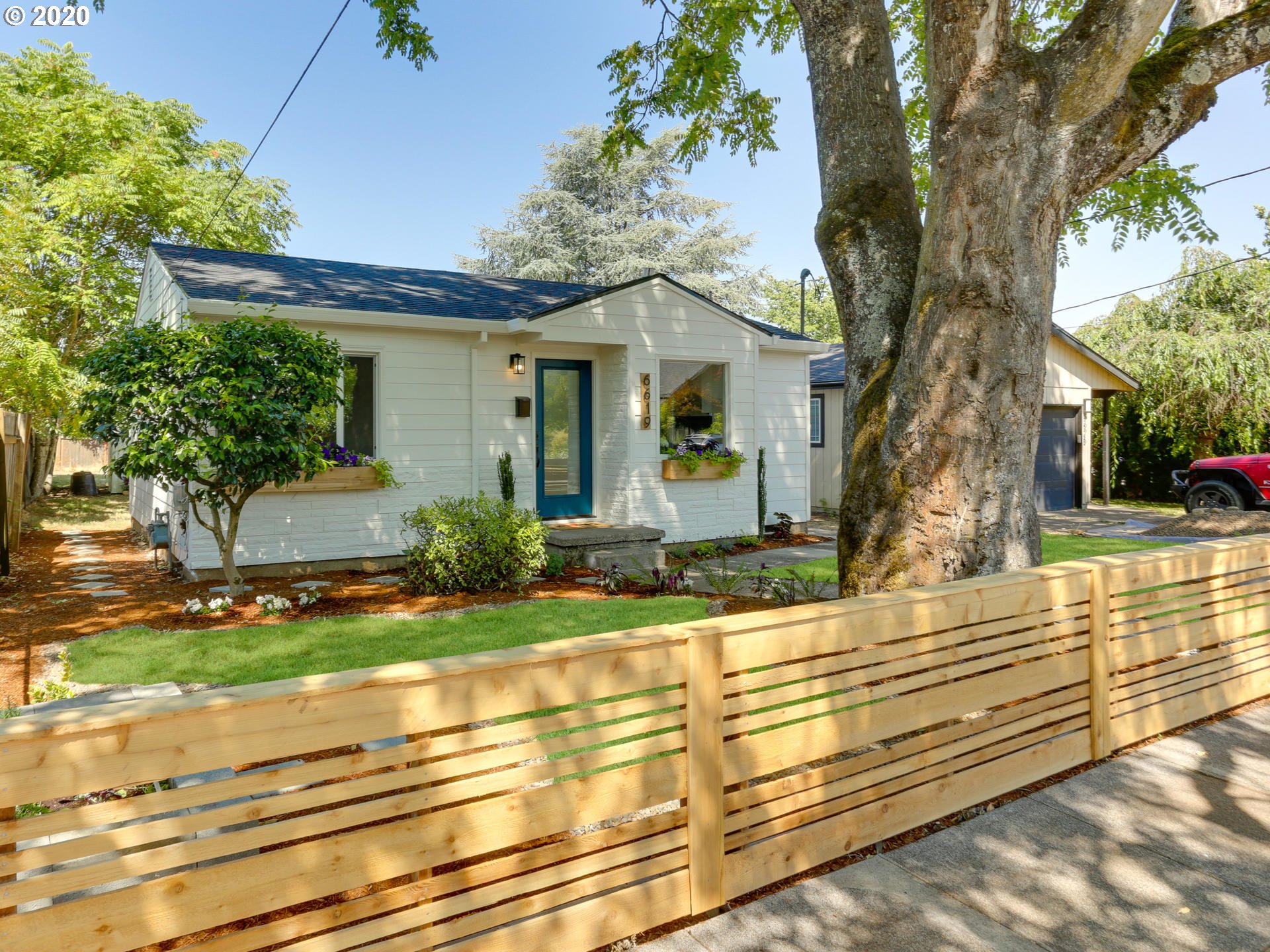 6619 Southeast Knight Street Portland, OR 97206 - Photo 3 of 30 a front view of a house with garden