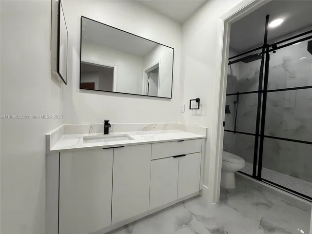 a bathroom with a double vanity sink and mirror