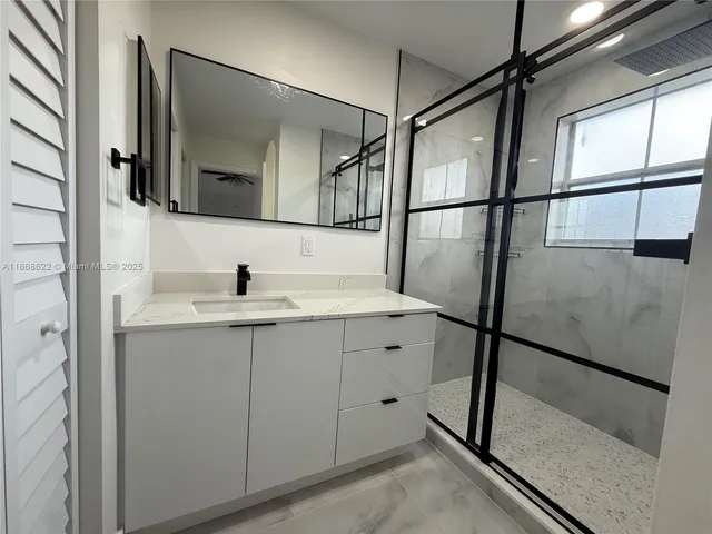 a bathroom with a sink and mirror