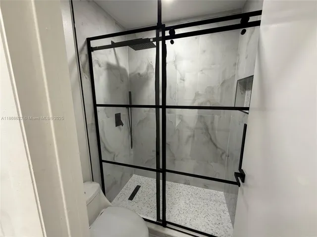 a bathroom with a glass shower door
