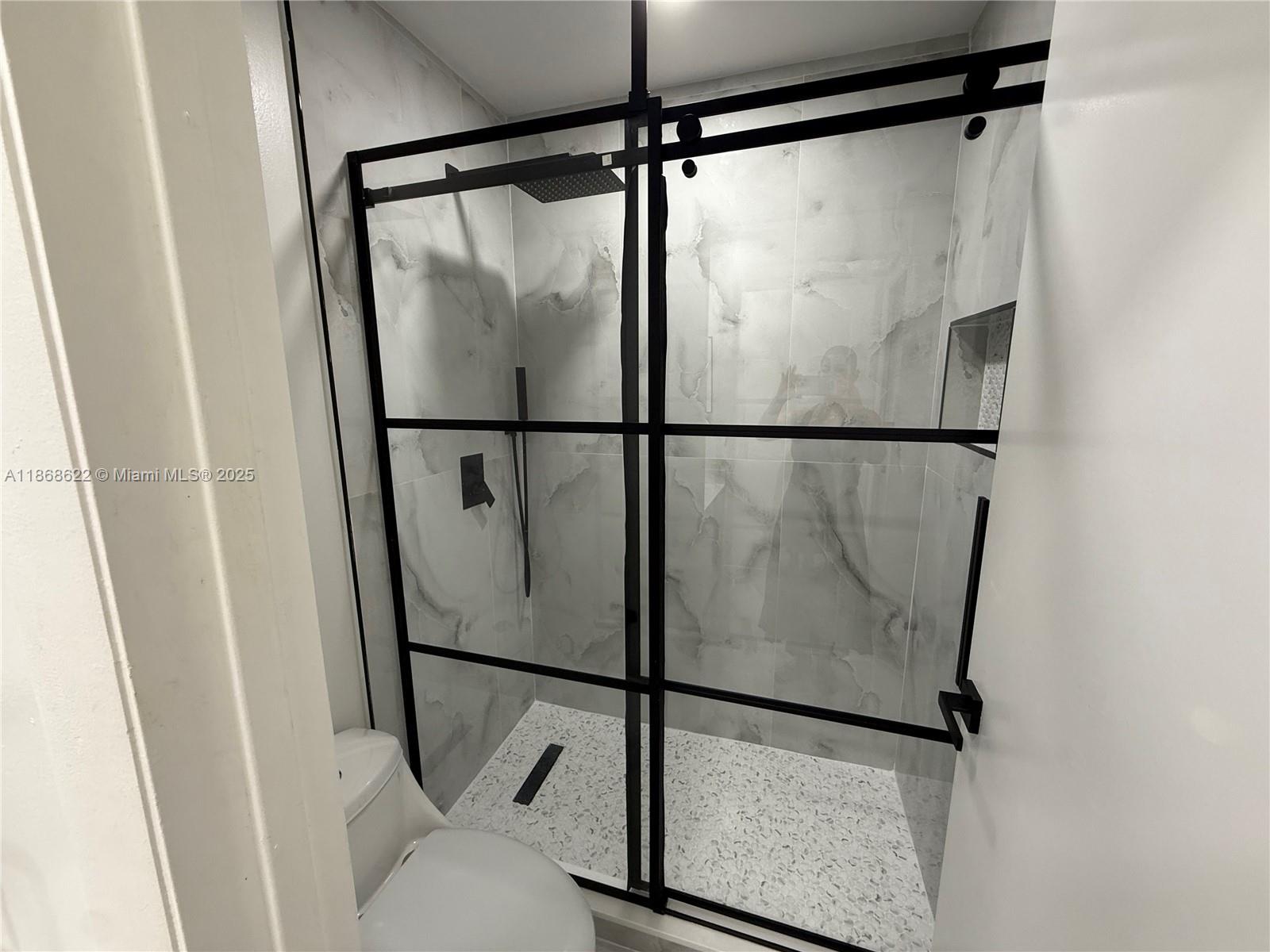 6955 Southwest 148 Lane Davie, FL 33331 - Photo 21 of 22 a bathroom with a glass shower door