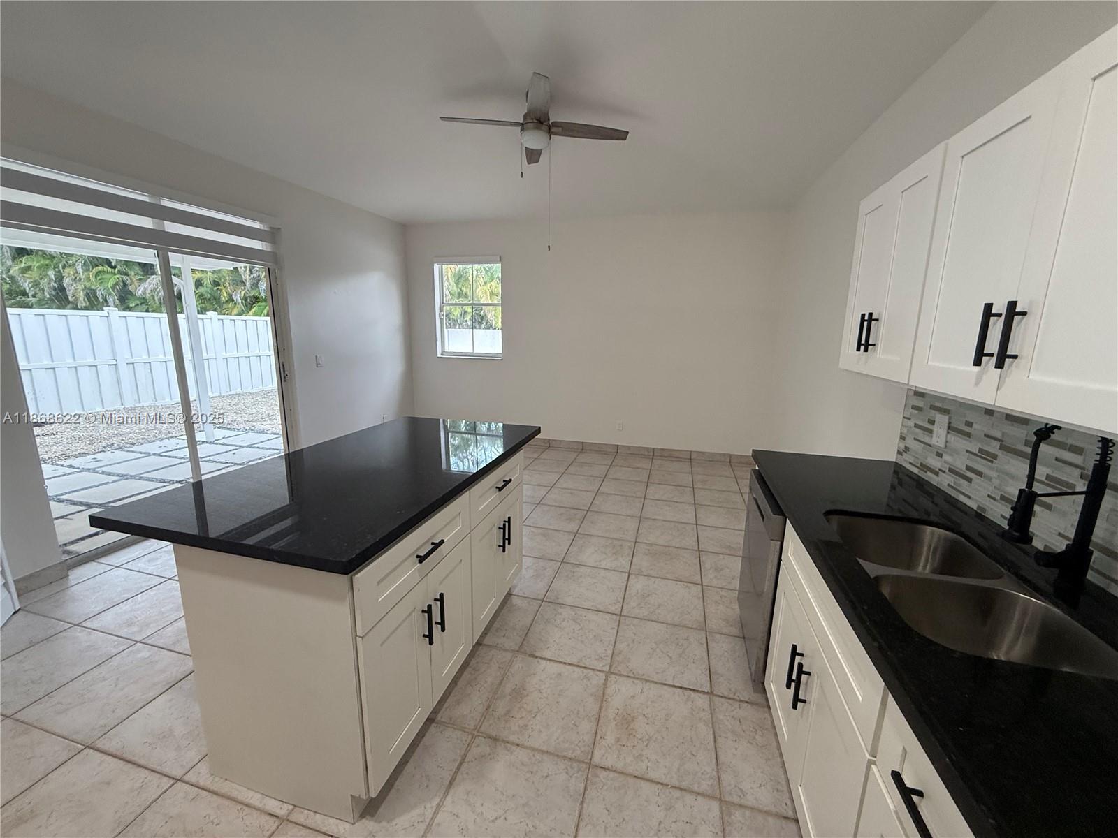 6955 Southwest 148 Lane Davie, FL 33331 - Photo 10 of 22 a kitchen with granite countertop a sink and a stove