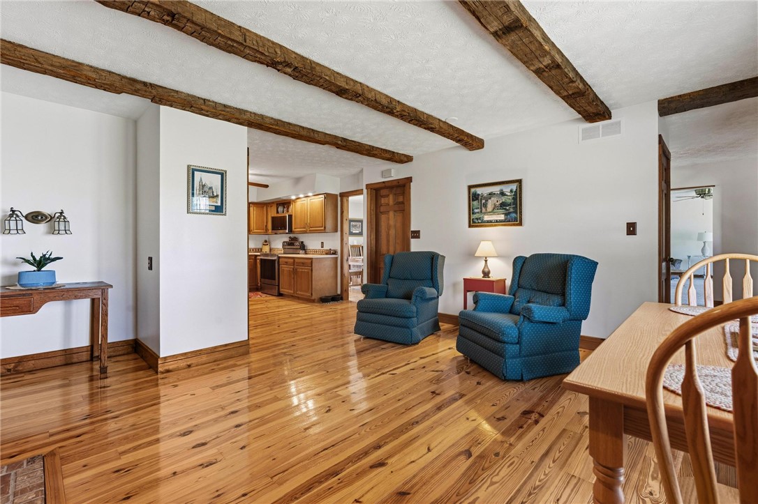 4971 Lackey Road Cedarville, OH 45314 - Photo 79 of 79 This inviting interior features a bright, open floorplan with exposed beam ceilings and warm hardwood flooring.