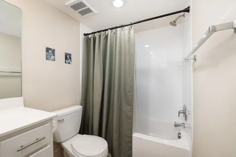 a bathroom with a shower a toilet and a sink