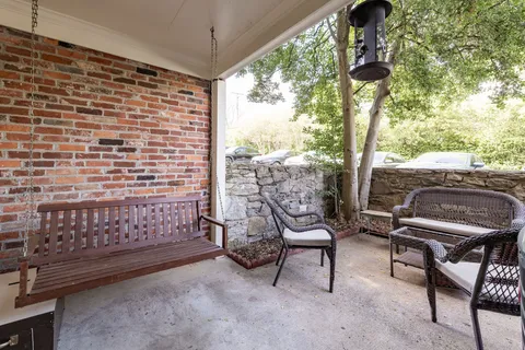 a view of a chairs and table in patio
