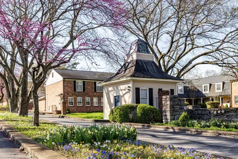 front view of a brick house with a yard