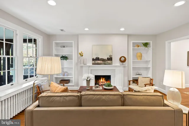 a living room with furniture and a fireplace