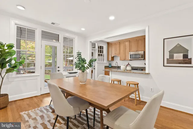 a dining room with furniture and wooden floor