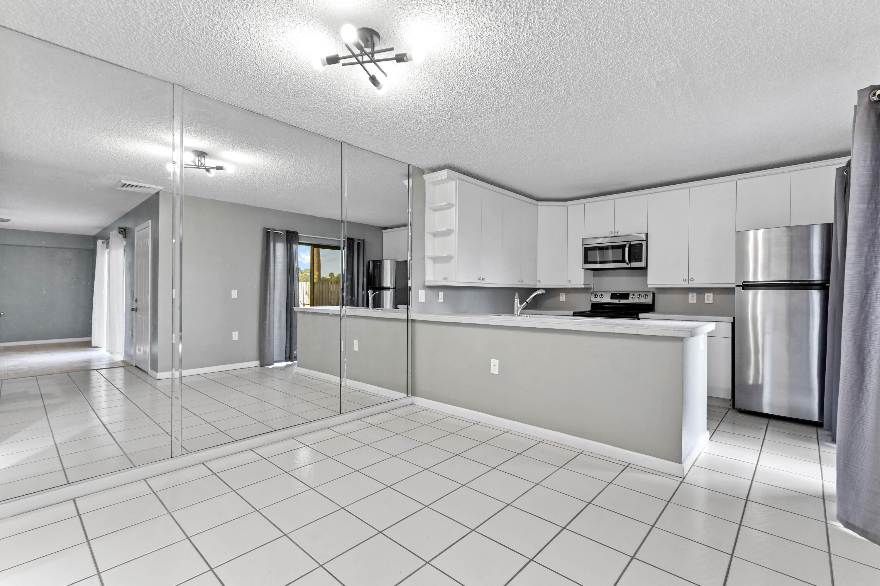 619 6th Way West Palm Beach, FL 33407 - Photo 7 of 24 a kitchen with cabinets and stainless steel appliances