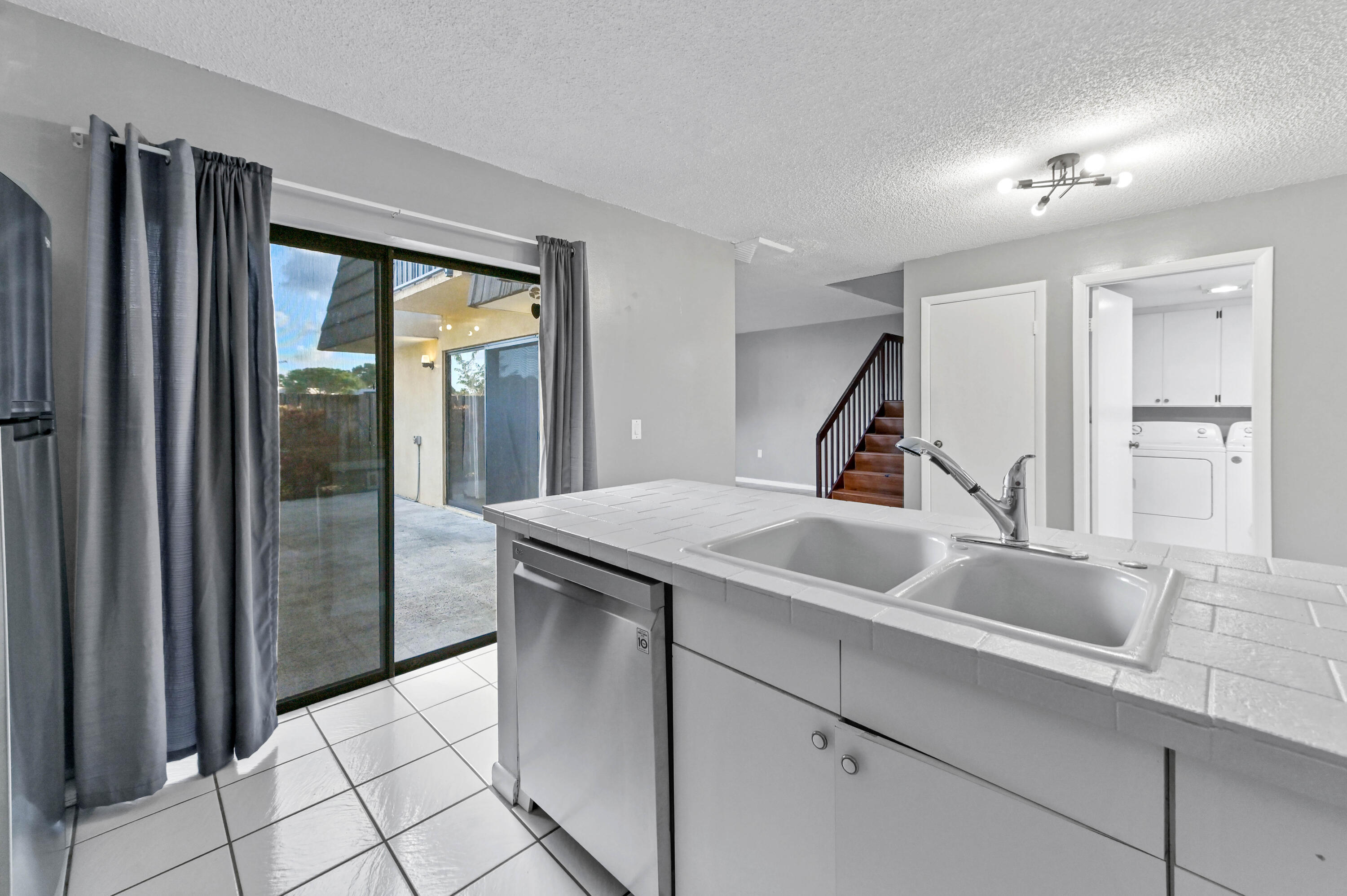 619 6th Way West Palm Beach, FL 33407 - Photo 10 of 24 a kitchen with a sink and refrigerator