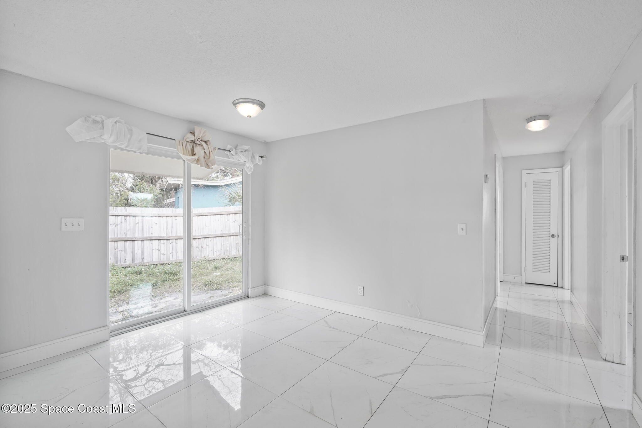 93 Prospect Avenue Cocoa, FL 32922 - Photo 12 of 25 a view of an empty room with a window