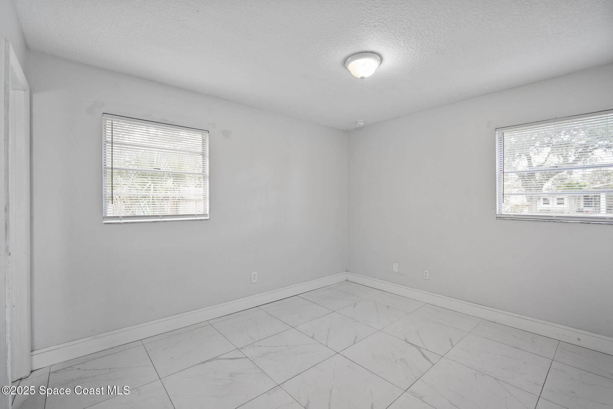 93 Prospect Avenue Cocoa, FL 32922 - Photo 16 of 25 an empty room with windows