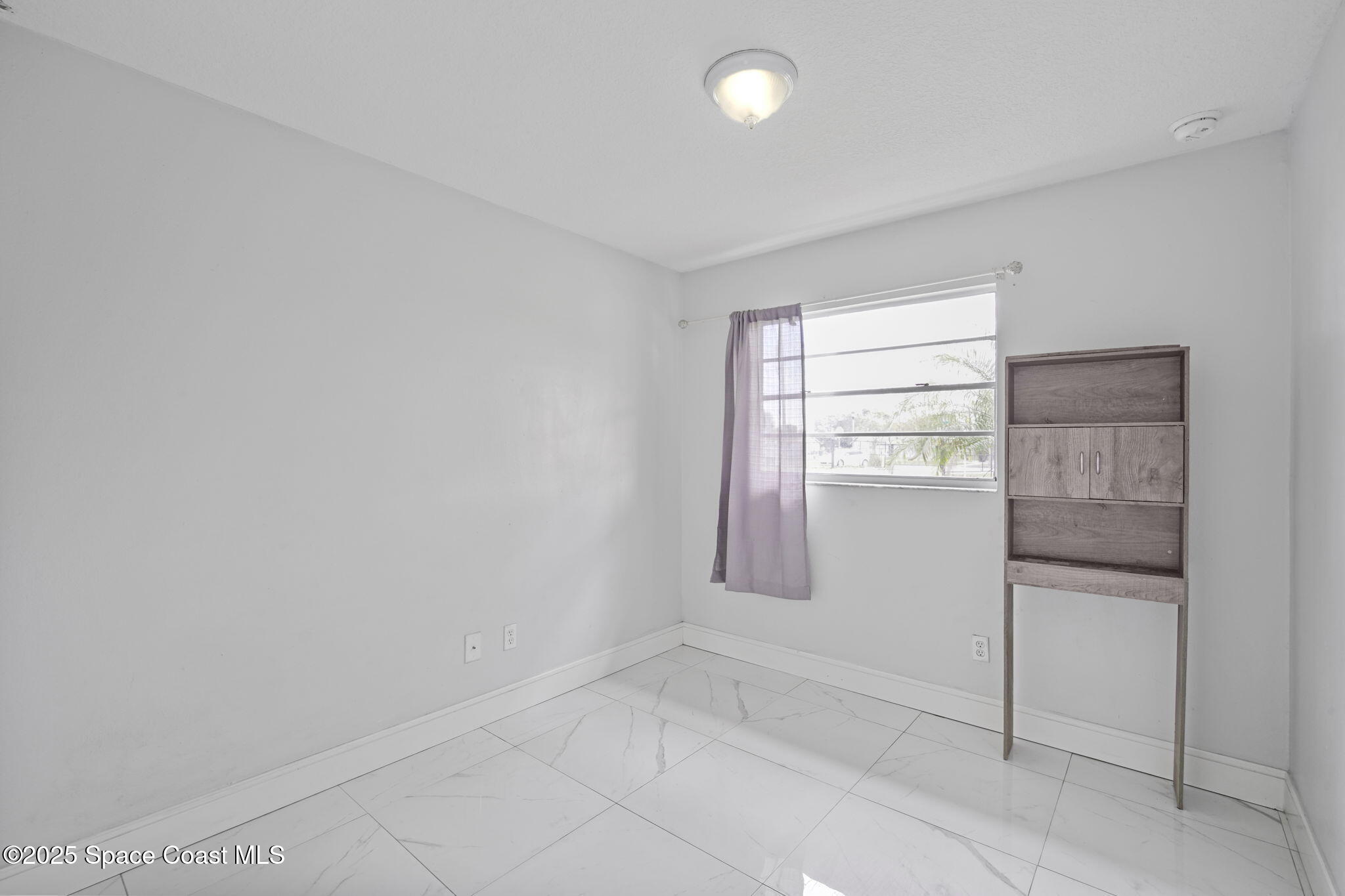93 Prospect Avenue Cocoa, FL 32922 - Photo 19 of 25 a view of an empty room with a window
