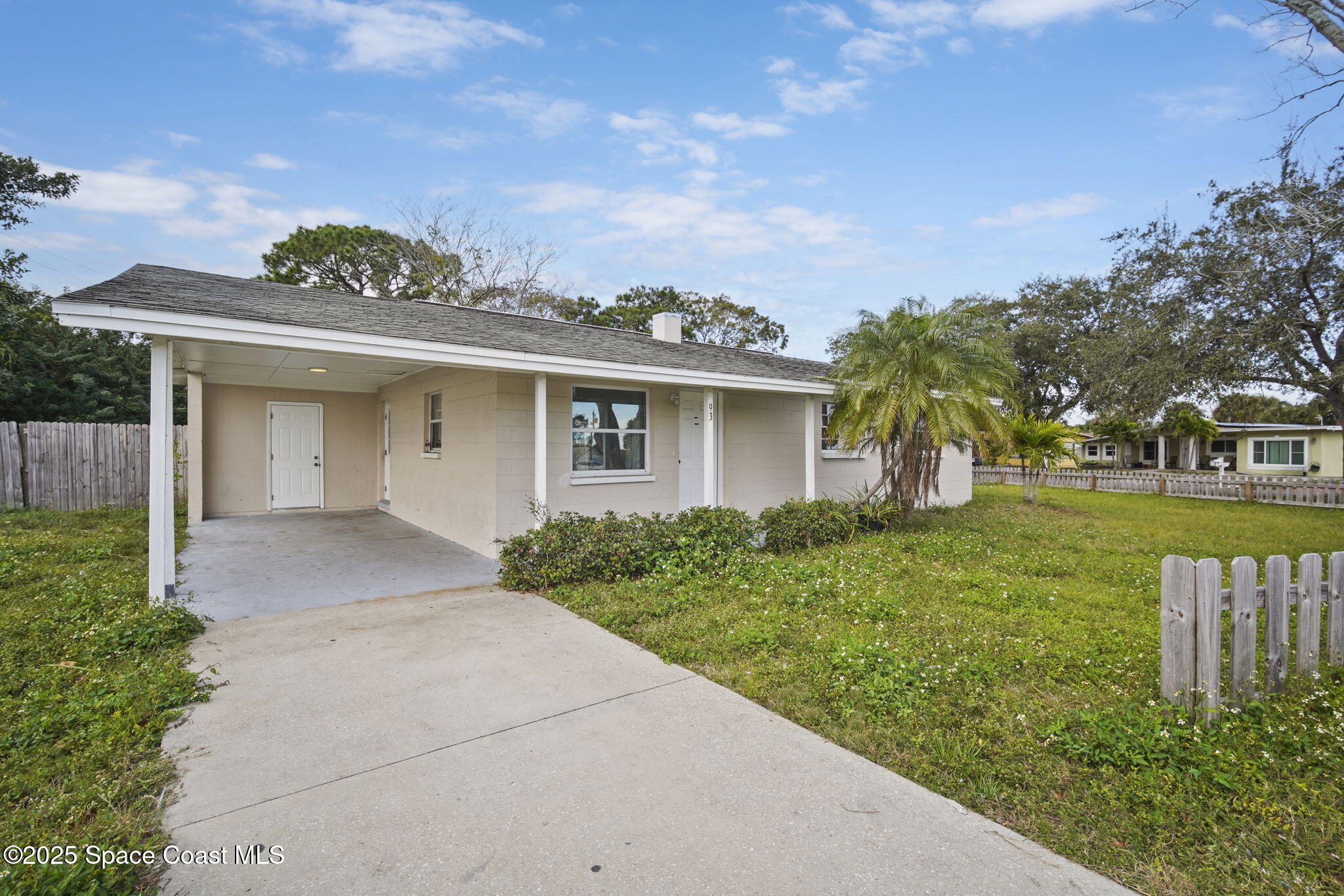 93 Prospect Avenue Cocoa, FL 32922 - Photo 2 of 25 a front view of a house with a yard and trees