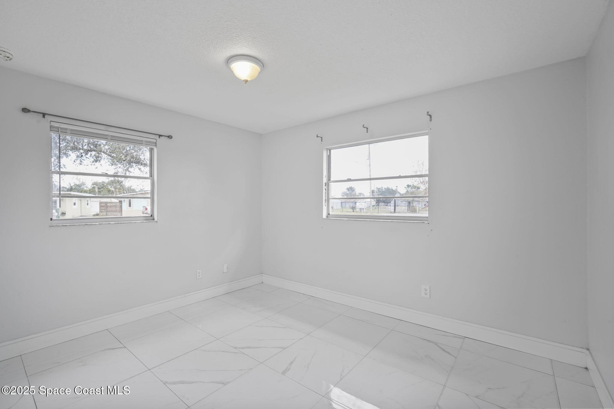 93 Prospect Avenue Cocoa, FL 32922 - Photo 21 of 25 an empty room with windows