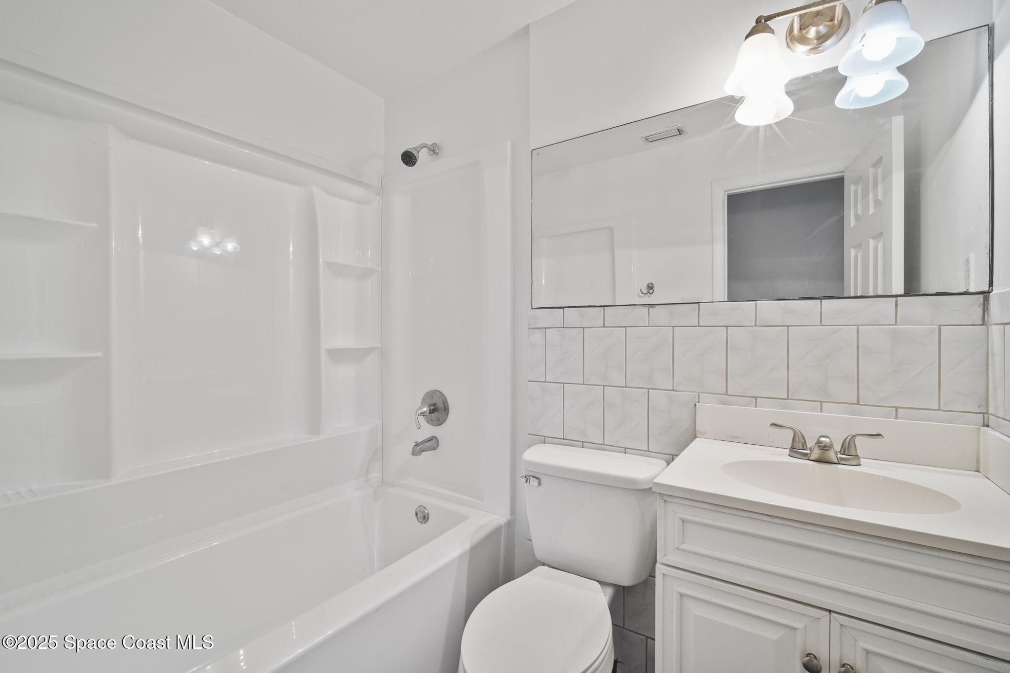 93 Prospect Avenue Cocoa, FL 32922 - Photo 22 of 25 a bathroom with a sink a toilet and shower