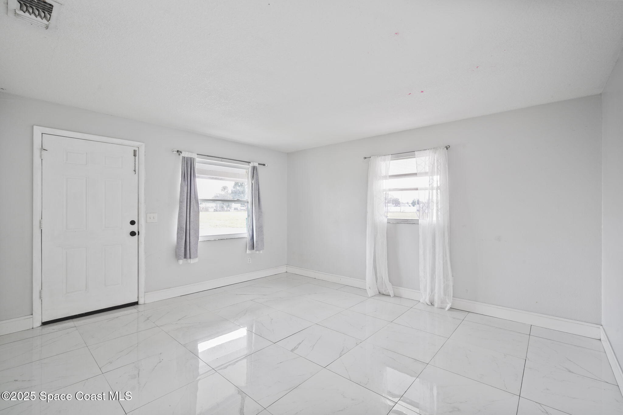 93 Prospect Avenue Cocoa, FL 32922 - Photo 4 of 25 a view of an empty room with a window