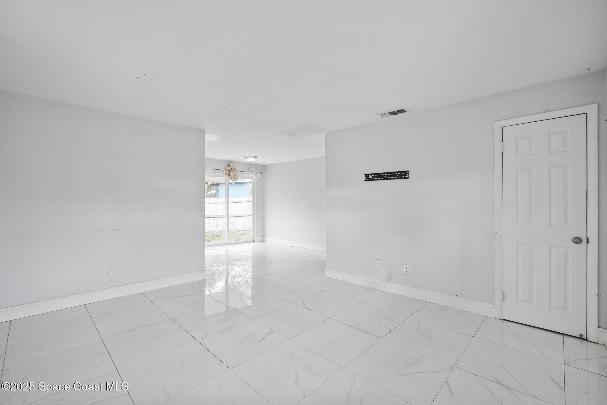 93 Prospect Avenue Cocoa, FL 32922 - Photo 5 of 25 a view of an empty room with a window