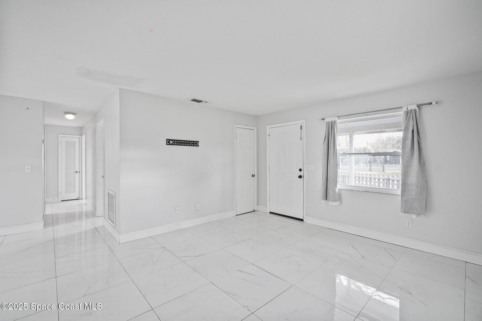 93 Prospect Avenue Cocoa, FL 32922 - Photo 7 of 25 a view of an empty room with a window
