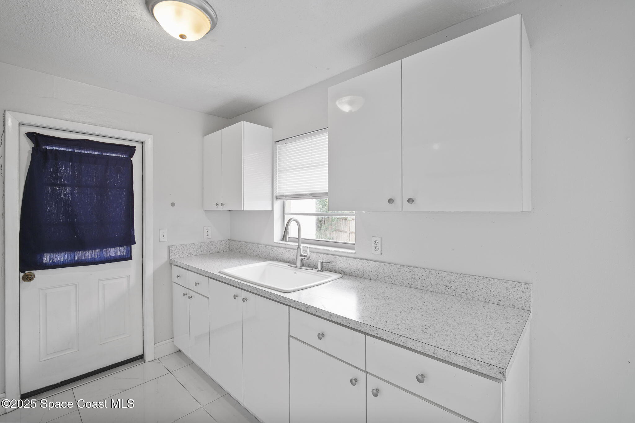 93 Prospect Avenue Cocoa, FL 32922 - Photo 8 of 25 a kitchen with a sink and cabinets