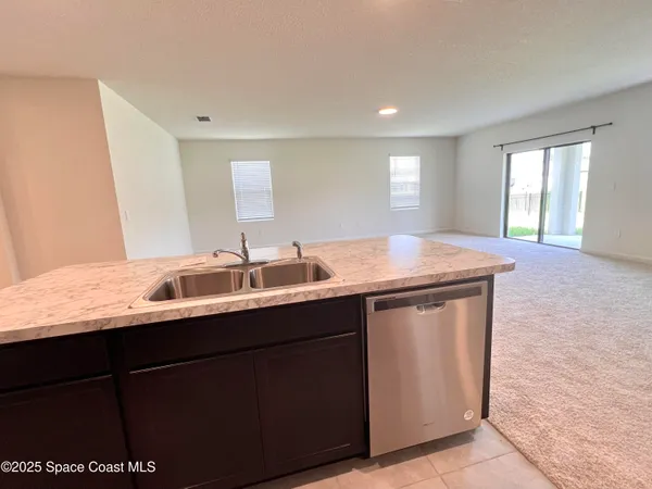 a large kitchen with cabinets and stainless steel appliances