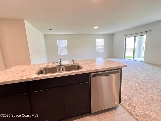 a large kitchen with cabinets and stainless steel appliances