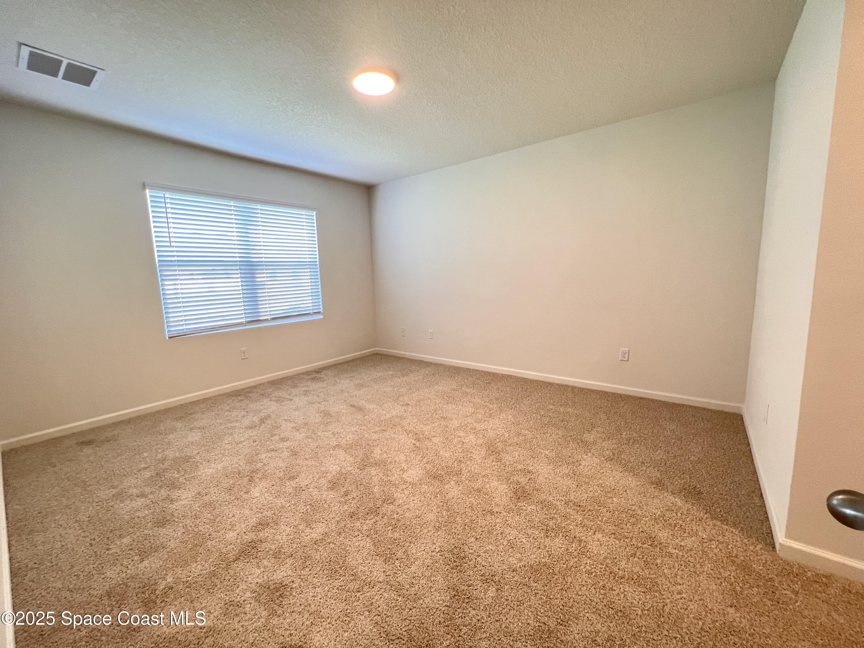 4631 Talbot Boulevard Cocoa, FL 32926 - Photo 15 of 24 an empty room with a window
