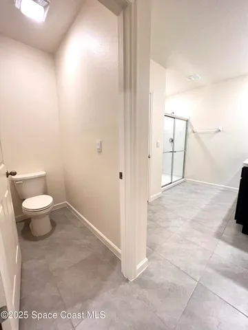 a bathroom with a glass shower door