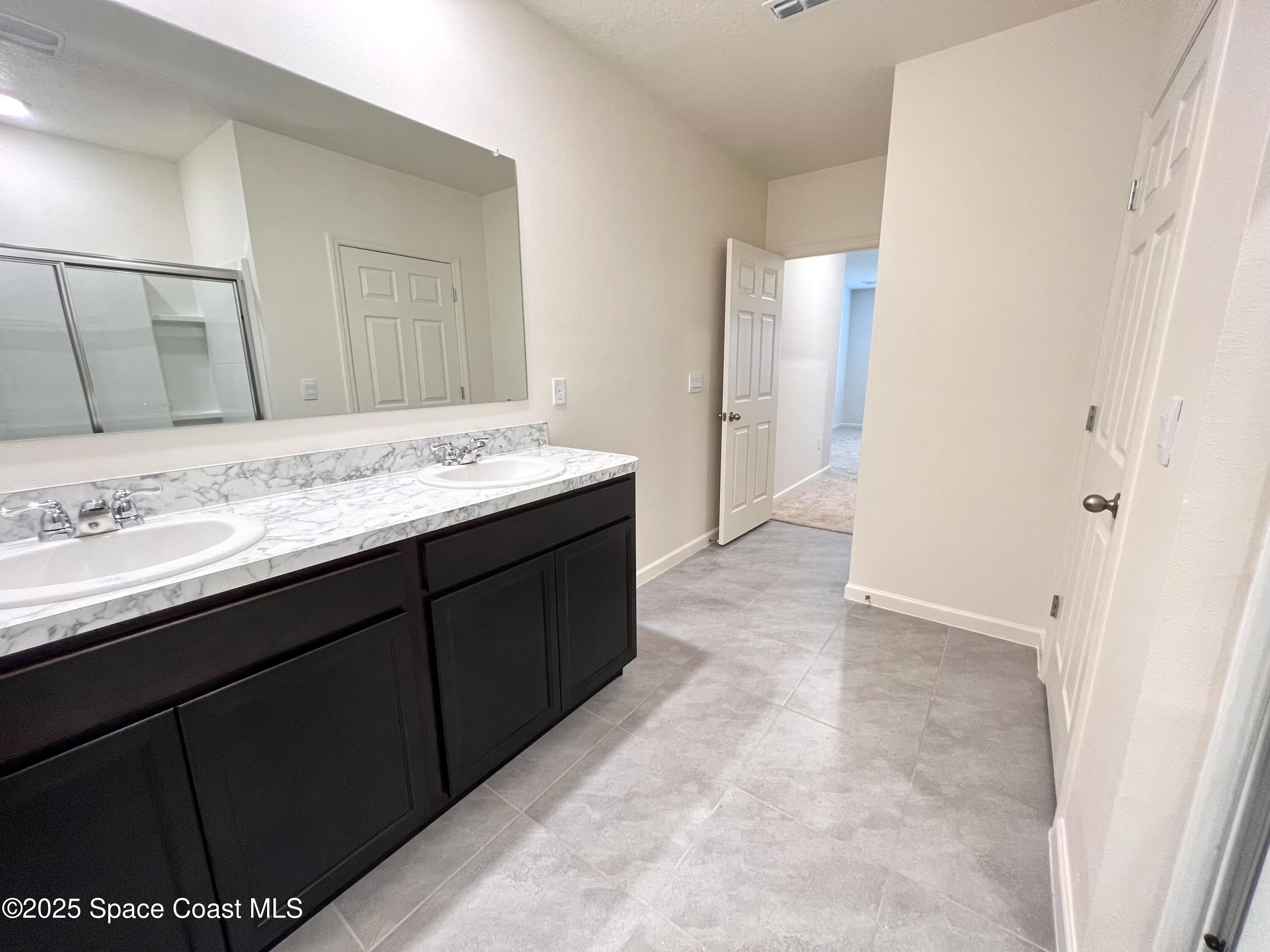 4631 Talbot Boulevard Cocoa, FL 32926 - Photo 19 of 24 a bathroom with a granite countertop sink a mirror and a vanity