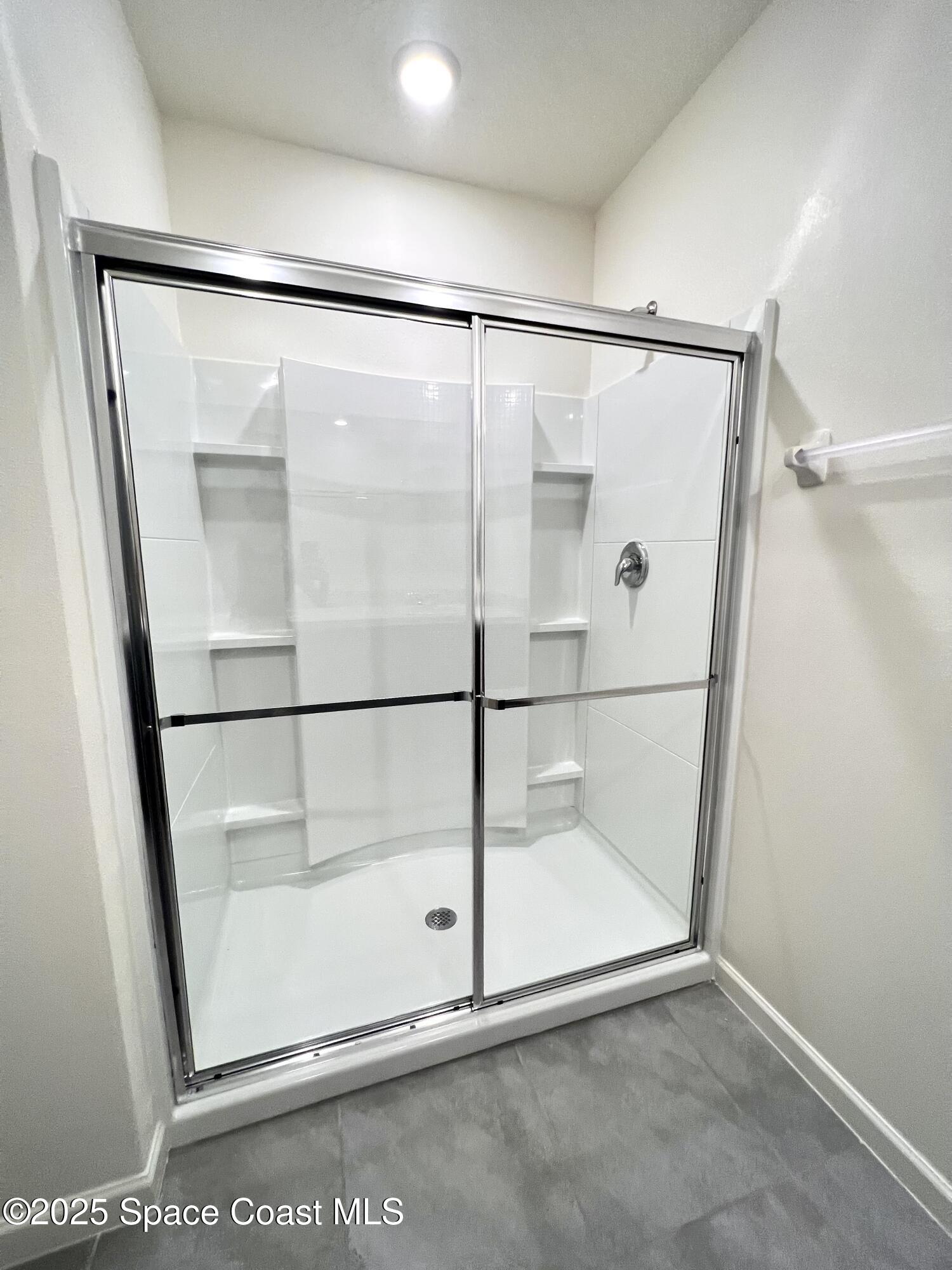 4631 Talbot Boulevard Cocoa, FL 32926 - Photo 20 of 24 a bathroom with a glass shower door
