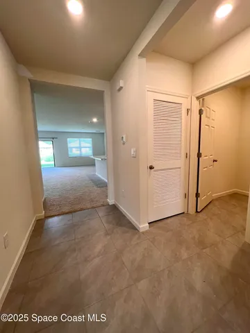 an empty room with windows and closet