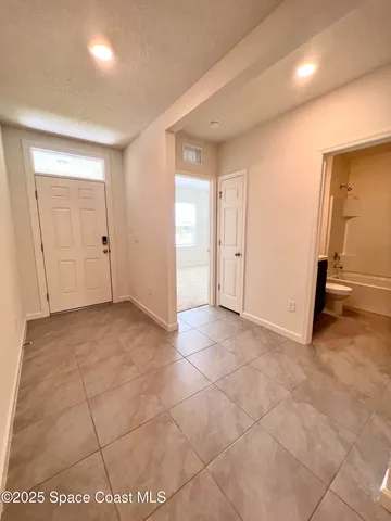 a bathroom with a granite countertop sink a toilet a mirror a bathtub and shower