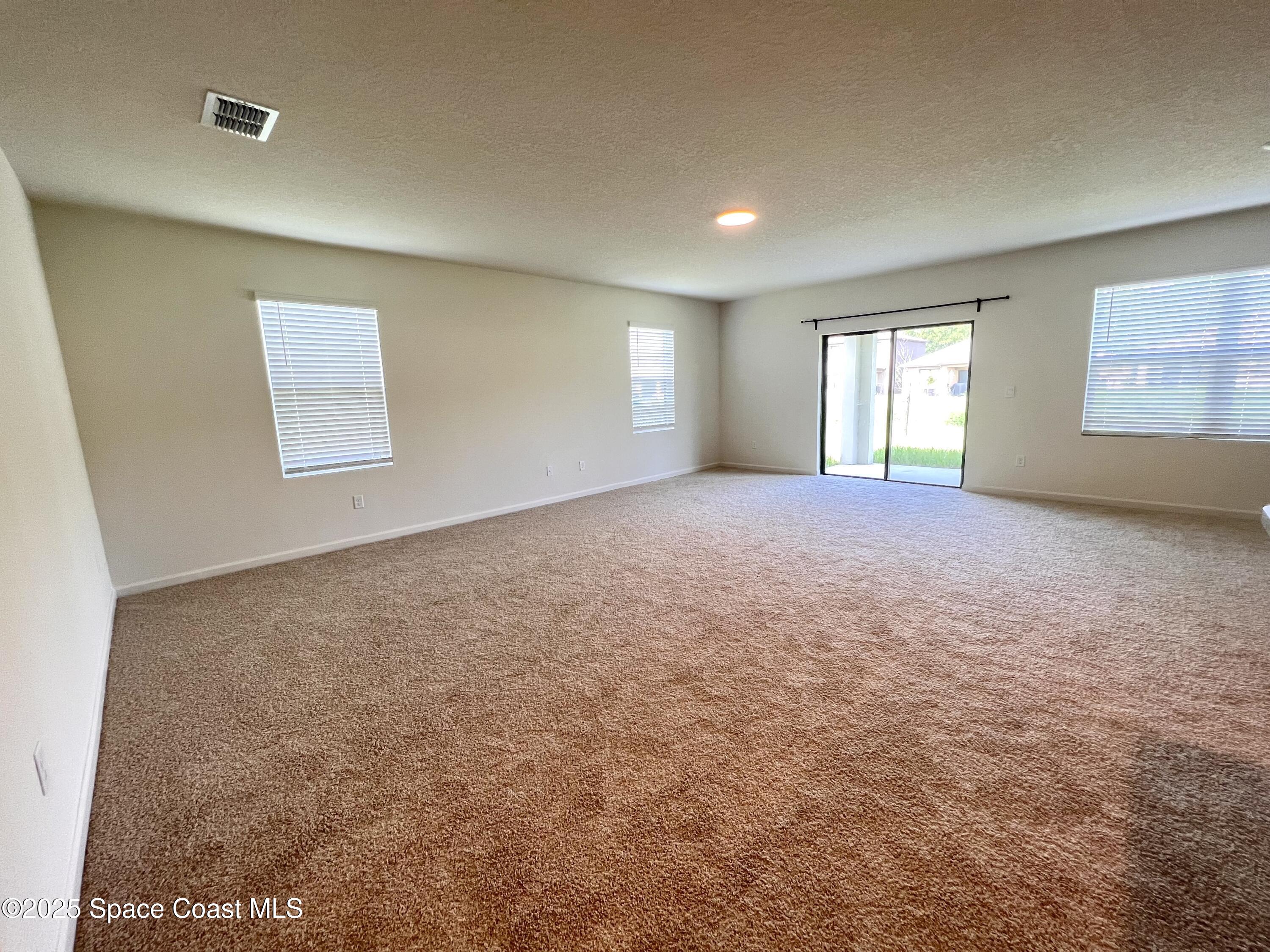 4631 Talbot Boulevard Cocoa, FL 32926 - Photo 8 of 24 an empty room with windows