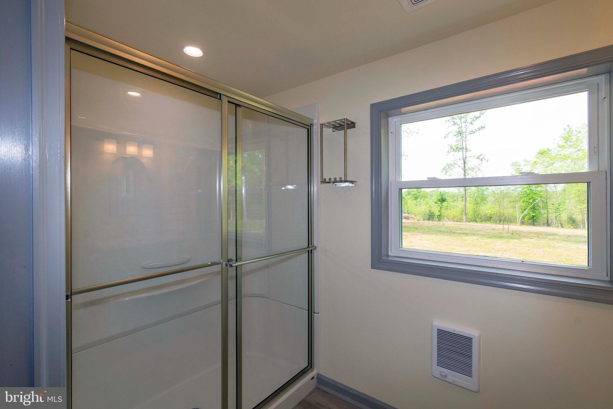 20738 Monrovia Road Orange, VA 22960 - Photo 13 of 50 a bathroom with a glass shower door