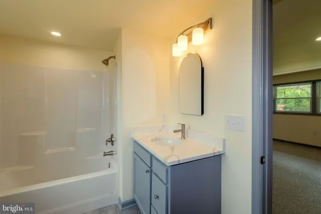 a bathroom with a sink a toilet and tub