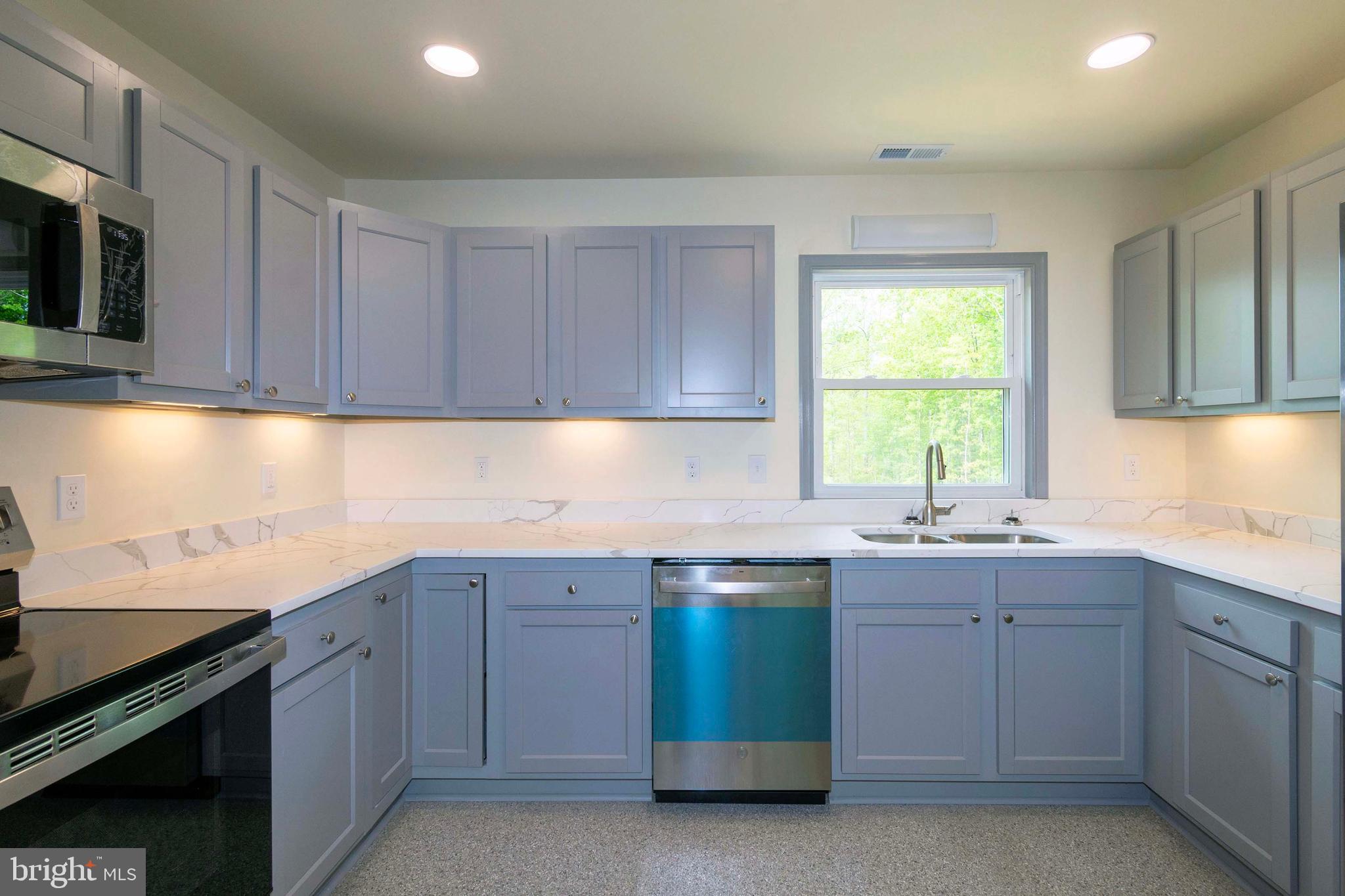 20738 Monrovia Road Orange, VA 22960 - Photo 19 of 50 a kitchen with a sink stove and cabinets