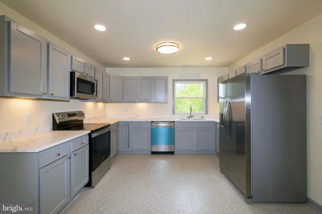 a kitchen with a sink and a stove top oven
