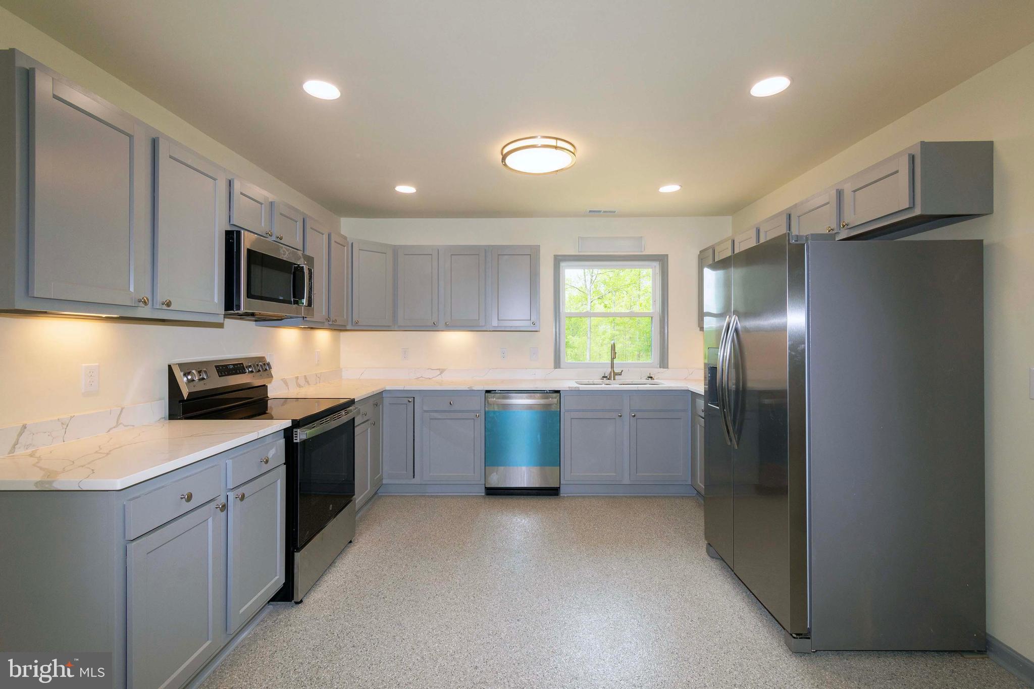 20738 Monrovia Road Orange, VA 22960 - Photo 20 of 50 a large kitchen with a stove a sink and a refrigerator