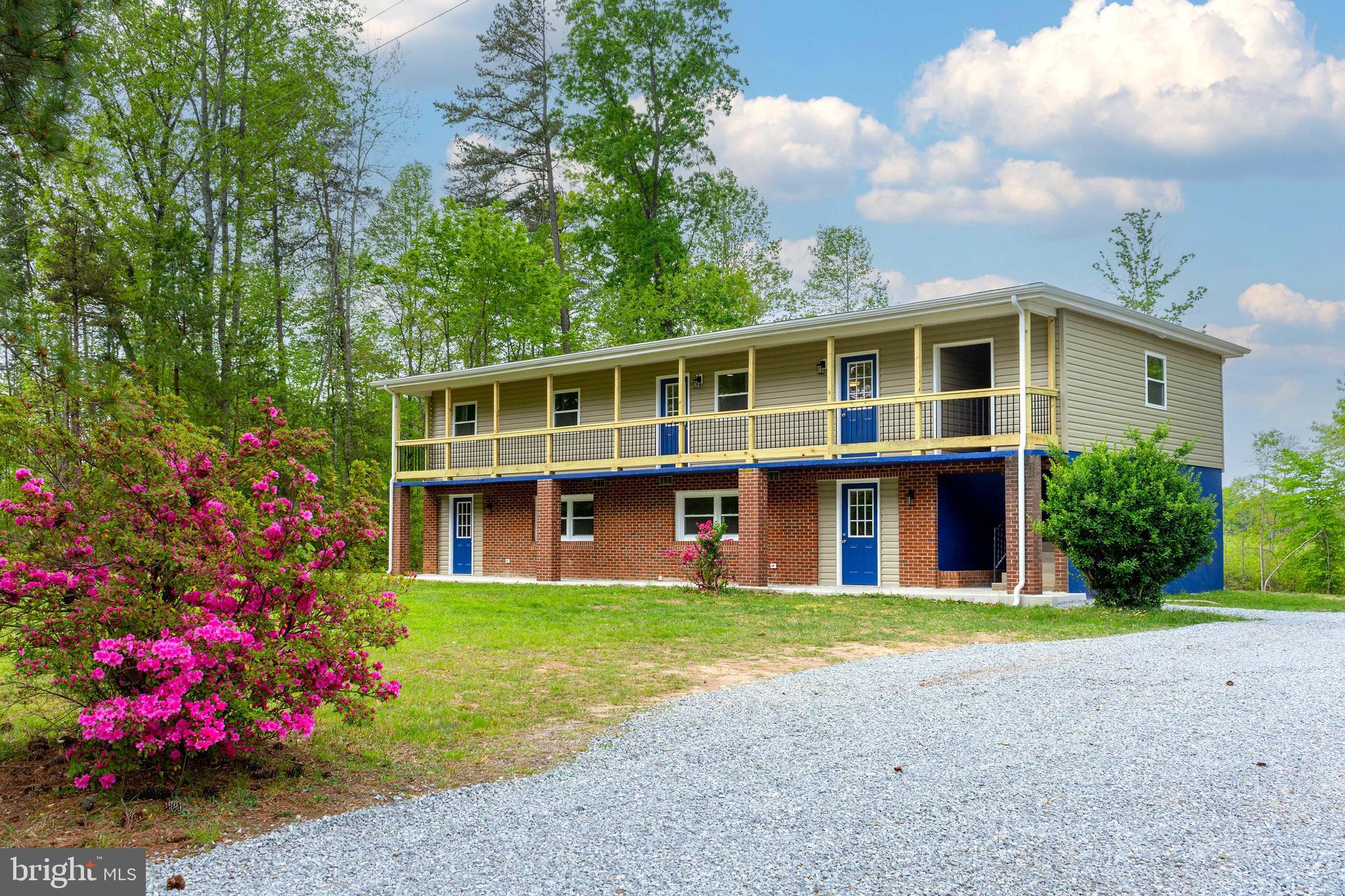 20738 Monrovia Road Orange, VA 22960 - Photo 2 of 50 a front view of a house with a yard and fountain in middle