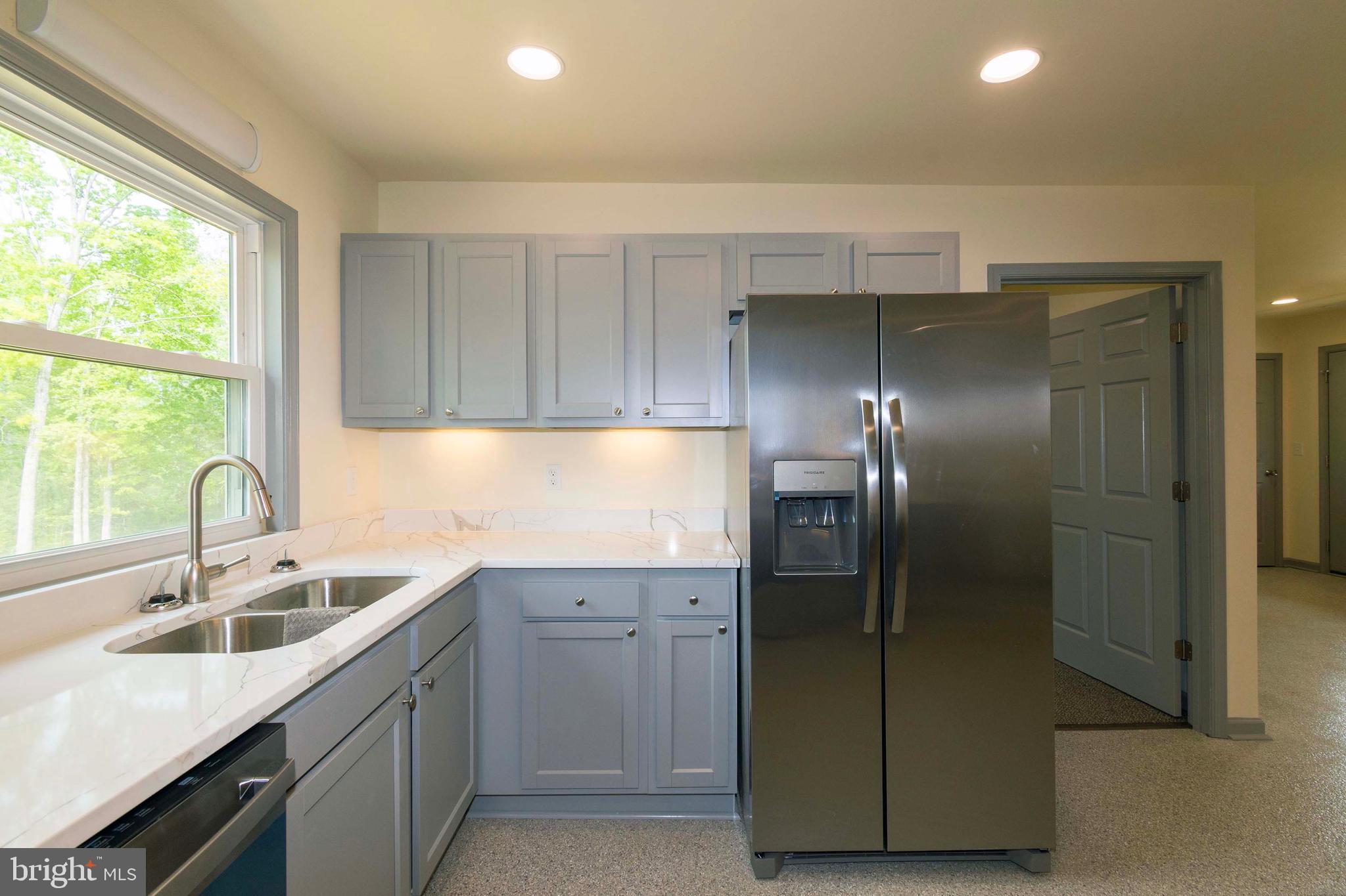 20738 Monrovia Road Orange, VA 22960 - Photo 22 of 50 a kitchen with a sink and refrigerator