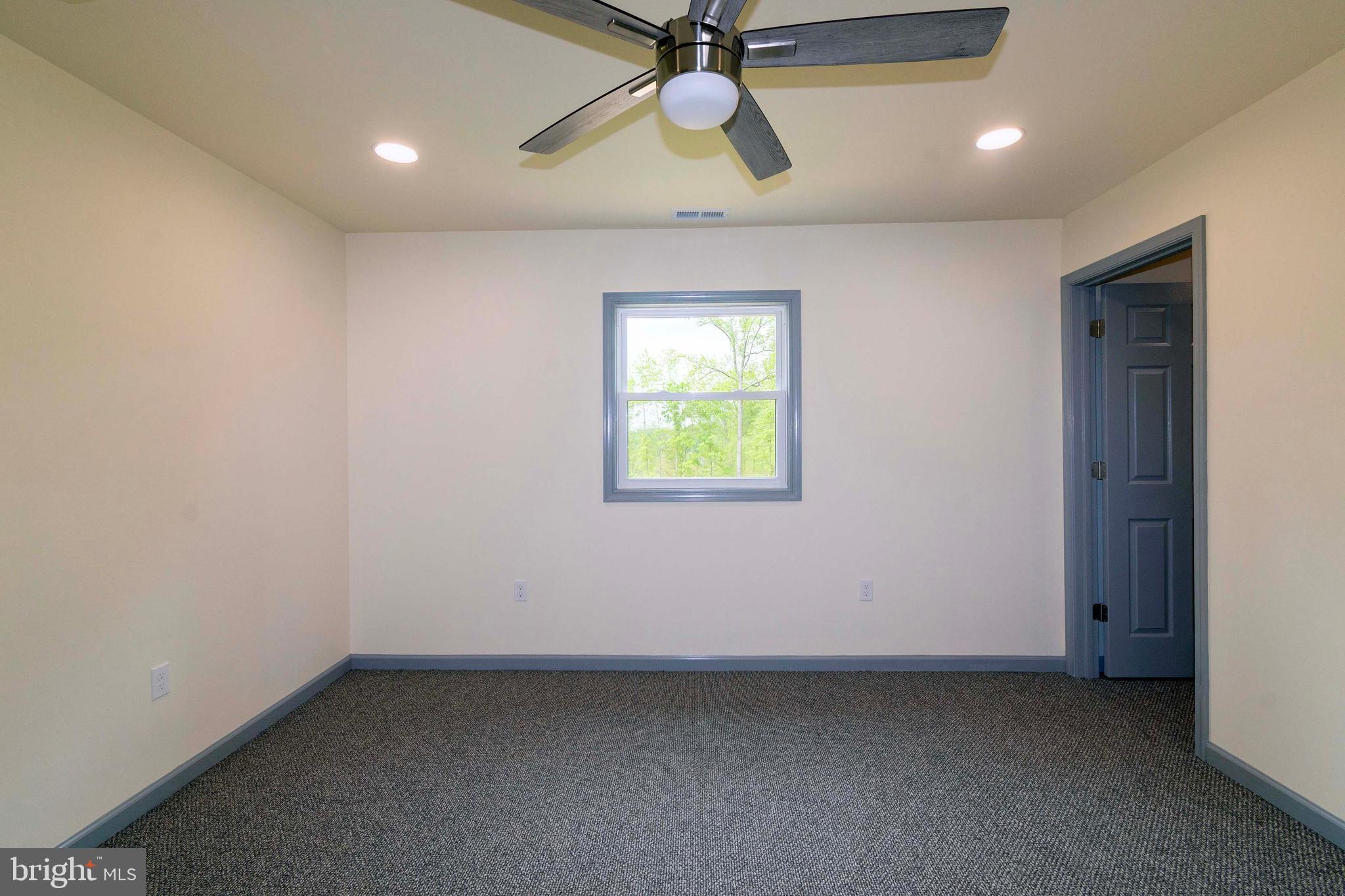 20738 Monrovia Road Orange, VA 22960 - Photo 27 of 50 an empty room with a window and a fan