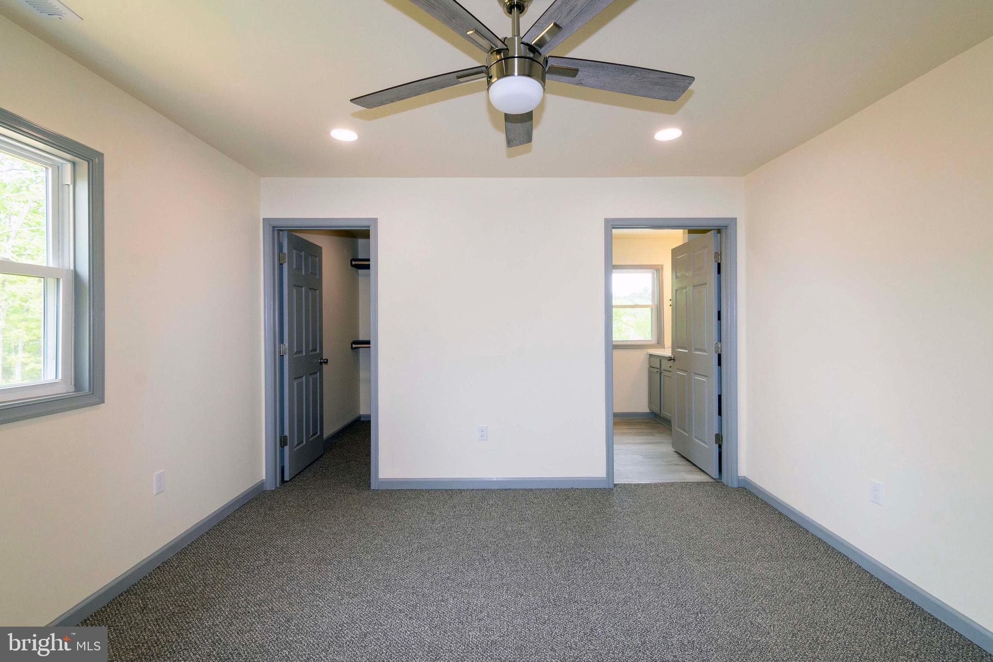 20738 Monrovia Road Orange, VA 22960 - Photo 28 of 50 an empty room with closet and a chandelier fan