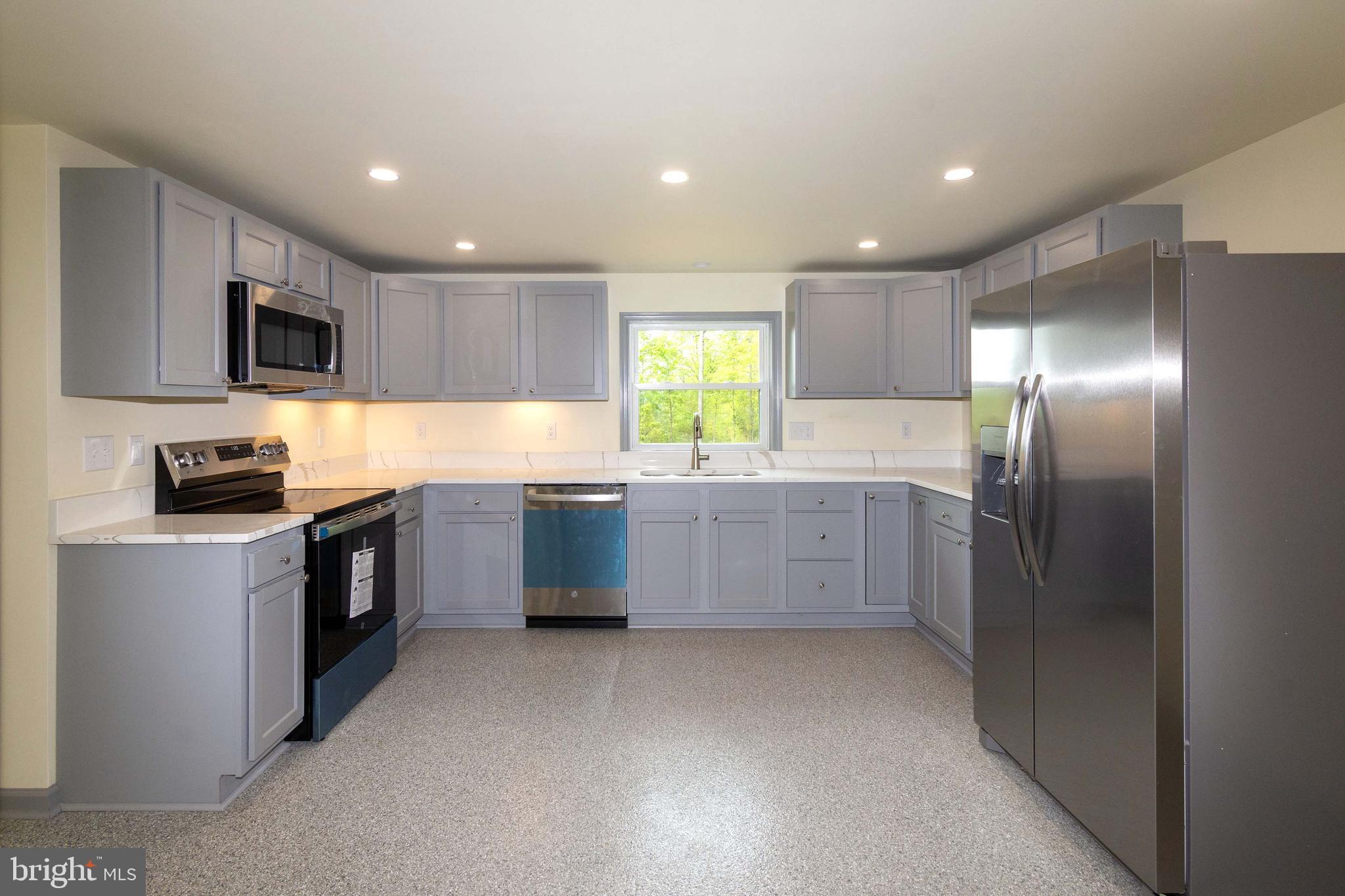 20738 Monrovia Road Orange, VA 22960 - Photo 10 of 50 a large kitchen with a stove a sink dishwasher a refrigerator and a microwave